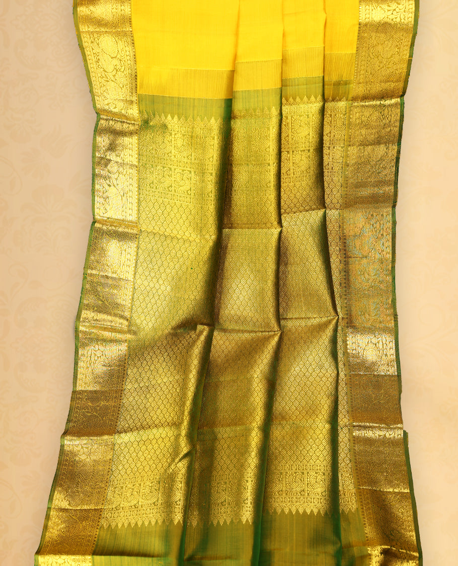 Mustard colour pure Kancheepuram saree with gold zari Mayoora chackra motifs on the body traditional contrast border with elephant and annam motifs grand pallu paired with matching blouse