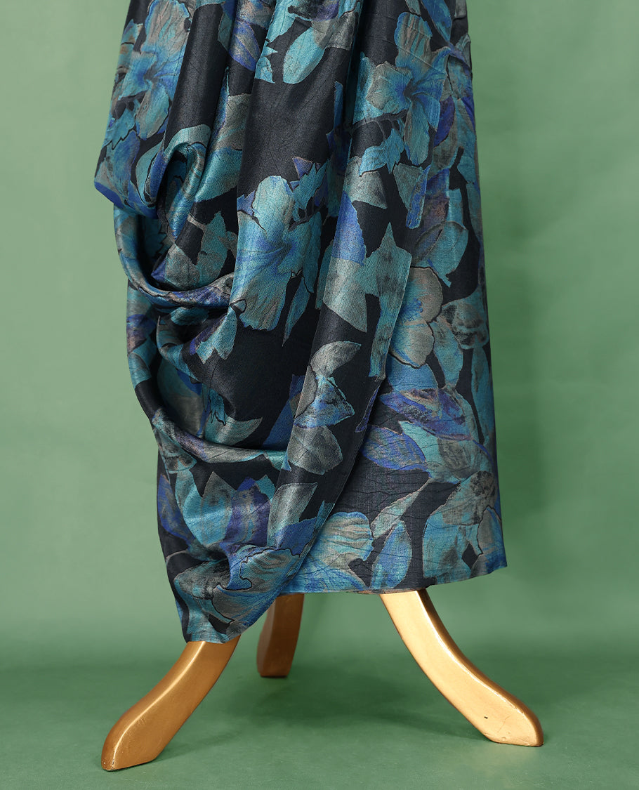 Charcoal black colour Manipuri saree featuring oversized teal and indigo floral motifs, finished without a border, and paired with a matching blouse.