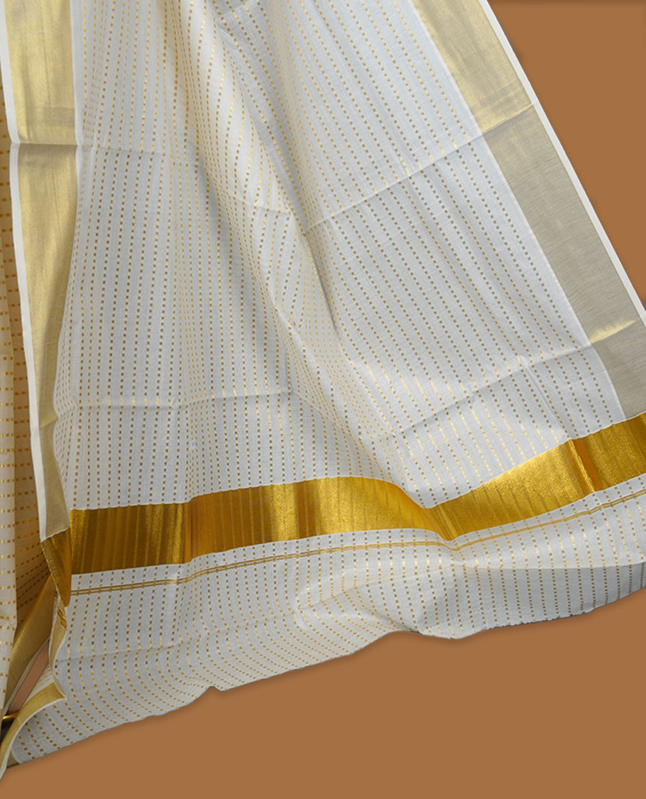 Off white colour cotton Kerala saree featuring fine dotted zari lines on the body, complemented by a classic golden zari border and traditional pallu, paired with a matching blouse.
