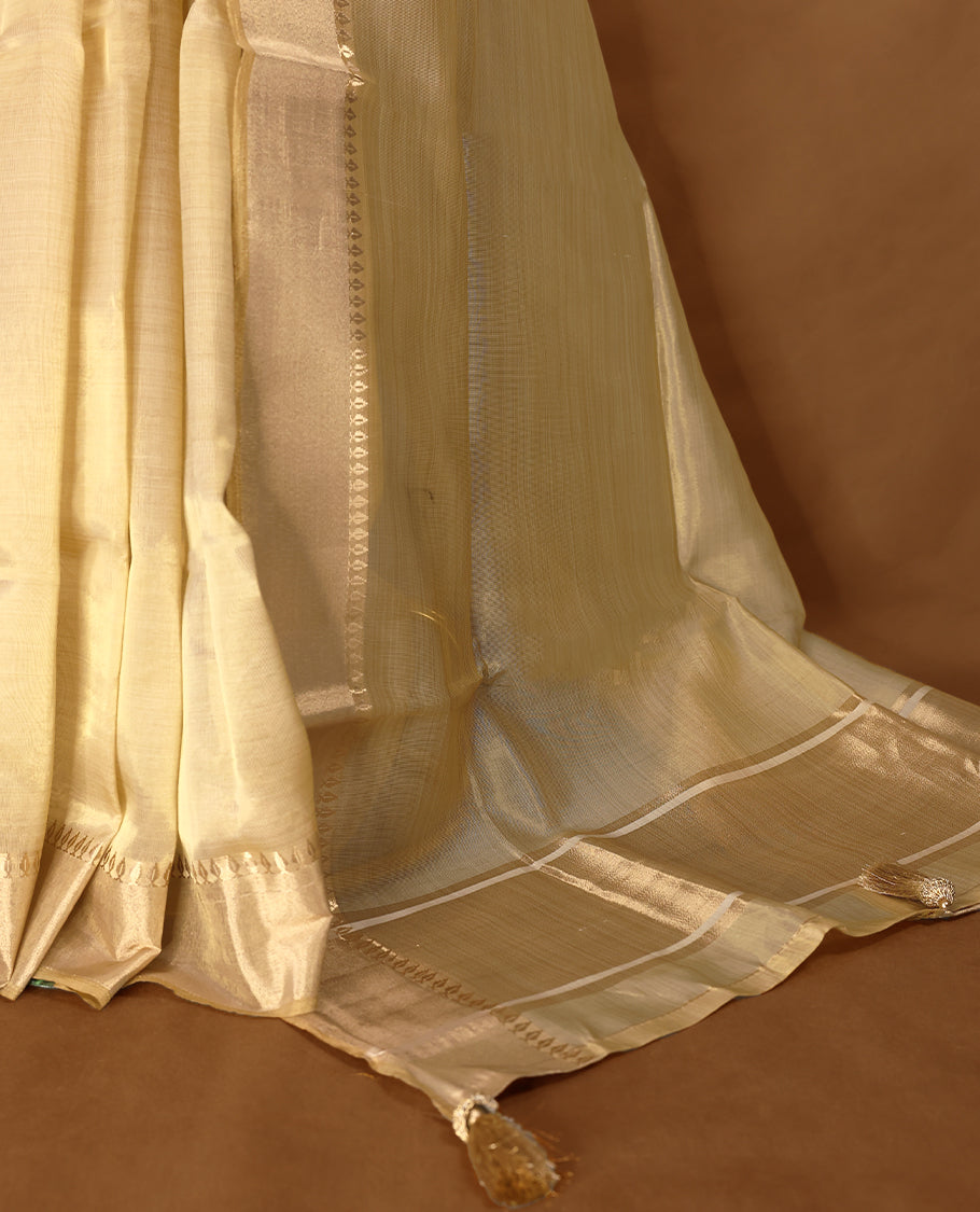 Elegant gold colour organza Kerala saree featuring a plain body, muted gold zari border, and a striking Gold Zari woven Bold pallu, paired with a matching blouse.