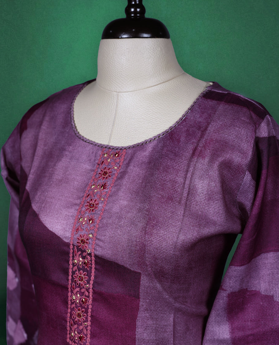 Plum purple colour kurti with a round neckline and three quarter sleeves, featuring abstract floral prints in soft lilac tones and a delicately Printed front placket for a graceful contemporary style.