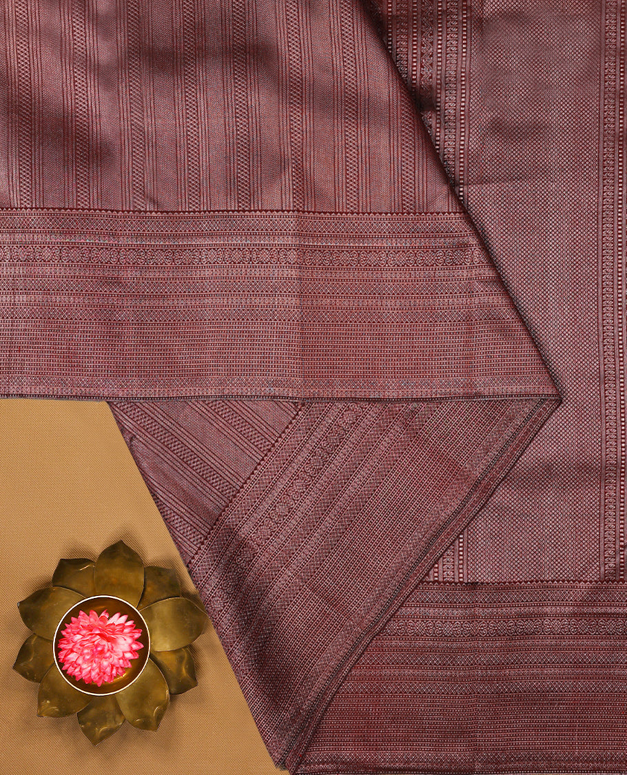 Maroon Colour Manthrakodi saree featuring an antique zari brocade body, complemented by a traditional Jada Naagam brocade border and a matching brocade blouse.
