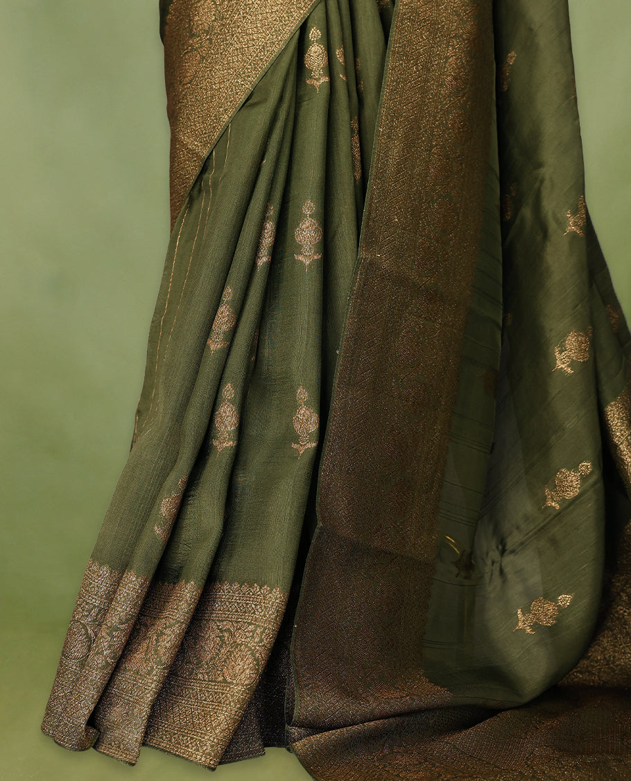 Army green semi-Banaras tussar georgette saree embellished with antique zari motifs across the body, complemented by a rich heritage Banaras border and paired with a matching blouse.