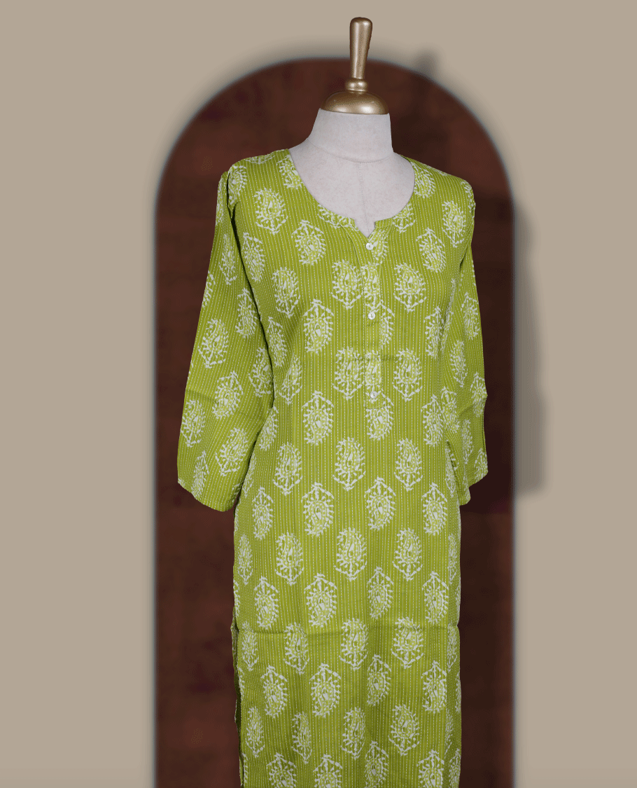 Light green colour printed kurti with round notch neck design and button detailing, straight 3/4th sleeves, and all-over white block floral prints.
