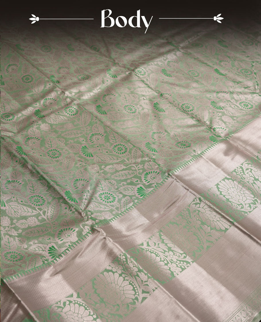 Pastel green colour and Antique gold Zari Tissue Brocade Saree features intricate floral Motifs on body and light rose gold border & pallu with floral patterns, paired with matching blouse