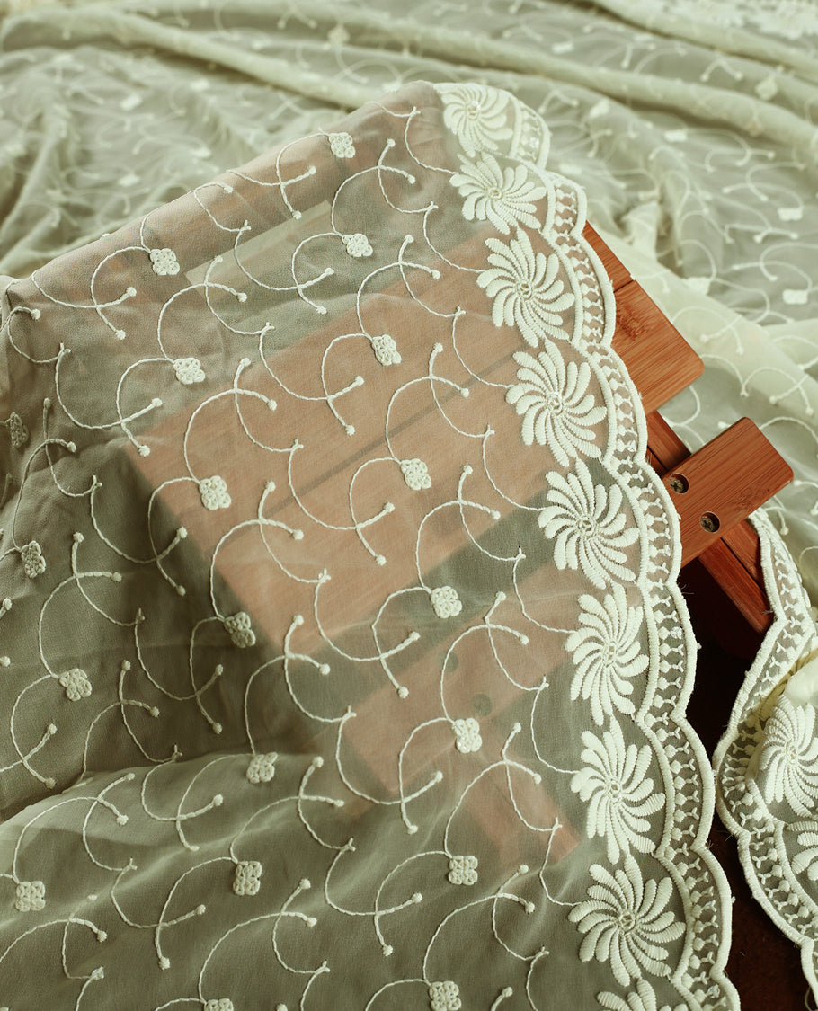 Elegant pista tinge colour churidhar material embellished with intricate floral embroidery and detailed thread patterns, paired with a plain matching bottom and embroidered dupatta, ideal for festive and elegant occasions.