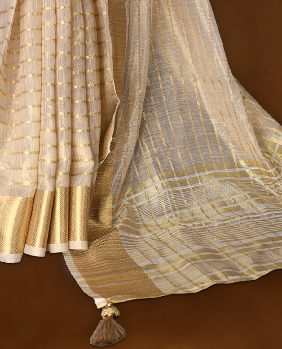 White & gold colour Organza Kerala saree featuring a smooth body with Gold zari Stripes, highlighted by a sleek golden zari border, Bold pallu Paired with a matching blouse.