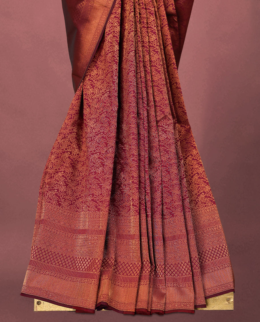 Maroon colour Kancheepuram saree featuring an antique zari brocade body, complemented by a traditional border and a matching blouse.