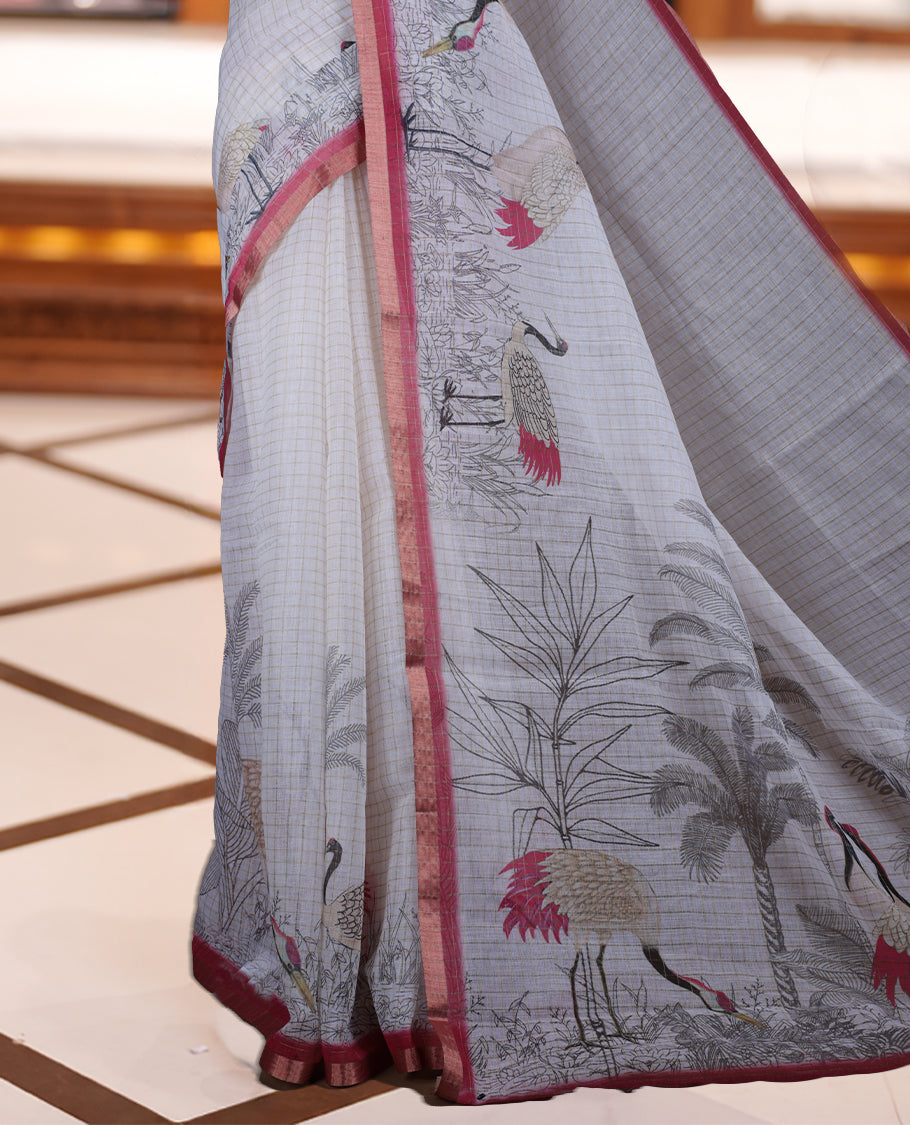 Off white colour Soft cotton saree featuring elegant bird prints along the edges, a stylish checked body, and a beautifully designed pink border & Paired with a matching blouse piece.