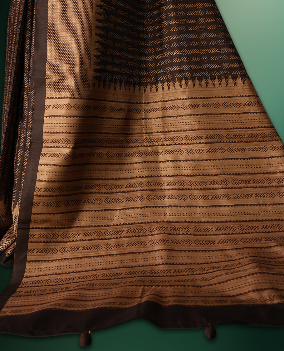 Deep Brown colour saree featuring prints all over the body, complemented by a sleek woven border and pallu, and paired with a matching blouse