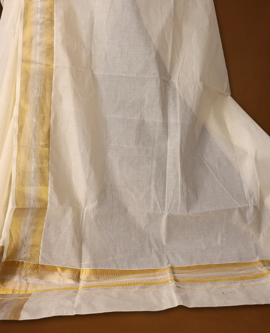 Traditional off white colour cotton Kerala saree featuring a subtle golden and silver dual tone zari border and pallu. Light, elegant, and perfect for festive or cultural occasions, it comes with a matching blouse piece.