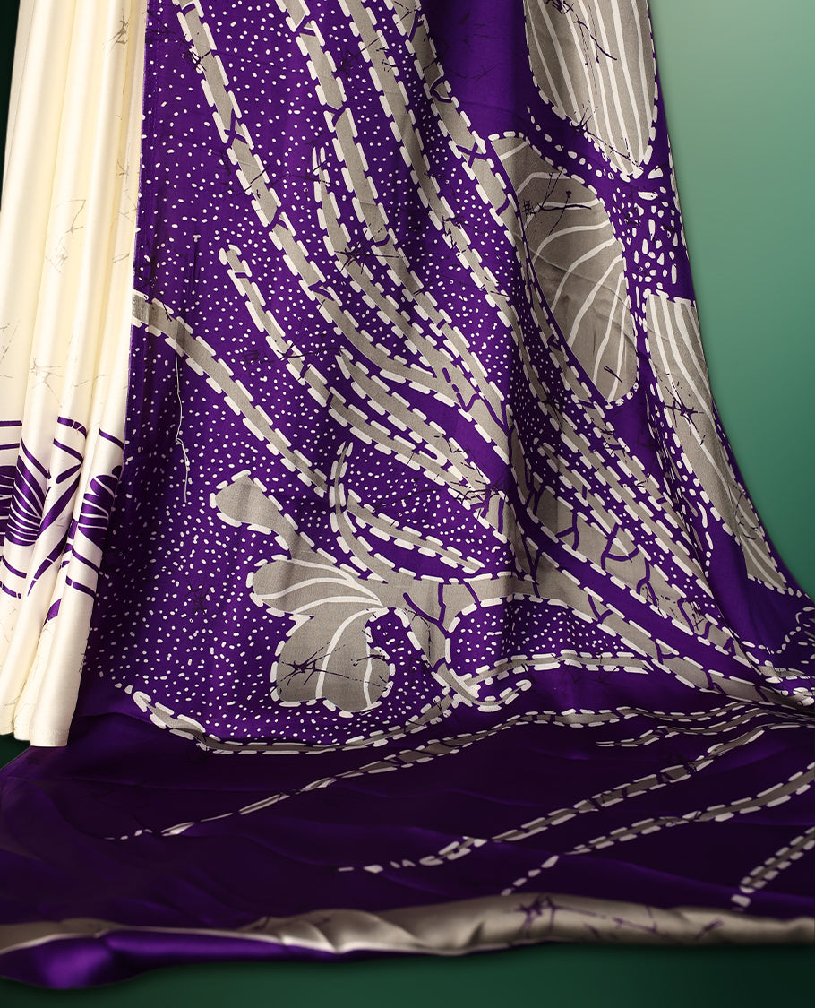 Purple colour Semi Modal saree featuring artistic abstract prints across the body, beautifully contrasted with Off White highlights, complemented by a bold patterned pallu, and paired with a matching blouse