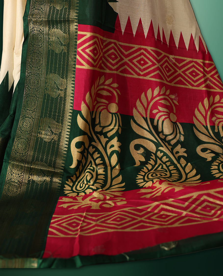 Off white colour saree with delicate golden motifs, highlighted by a striking pink upper border, rich green zari woven border, and a contrasting red and green pallu with intricate floral and geometric designs, paired with a matching blouse