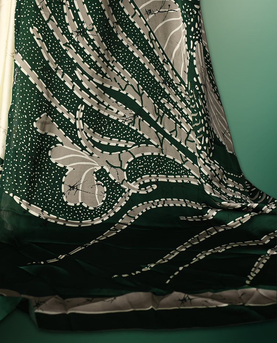 Dark Green colour Semi Modal saree featuring artistic abstract prints across the body, beautifully contrasted with Off White highlights, complemented by a bold patterned pallu, and paired with a matching blouse