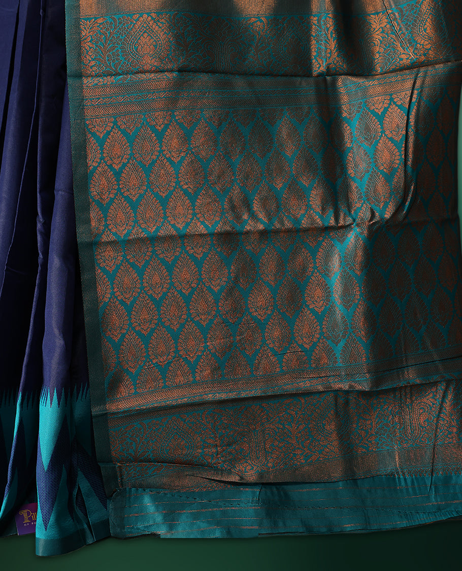 Navy blue colour saree adorned with bold turquoise zigzag woven patterns along the border and pallu, finished with a rich metallic woven design, paired with a matching blouse