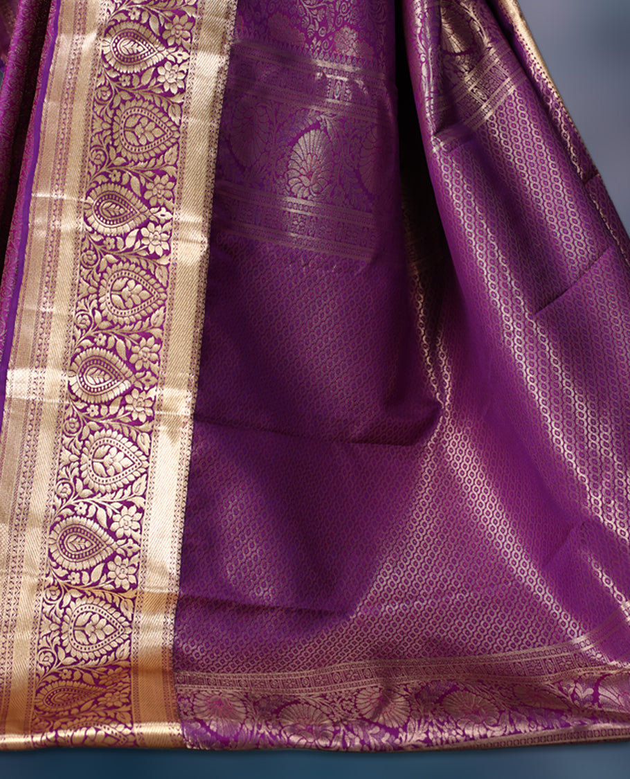 Purple semi silk brocade saree with rich gold zari brocade work all over, complemented by an intricately woven gold border and pallu, Comes with a matching blouse for a grand traditional look.