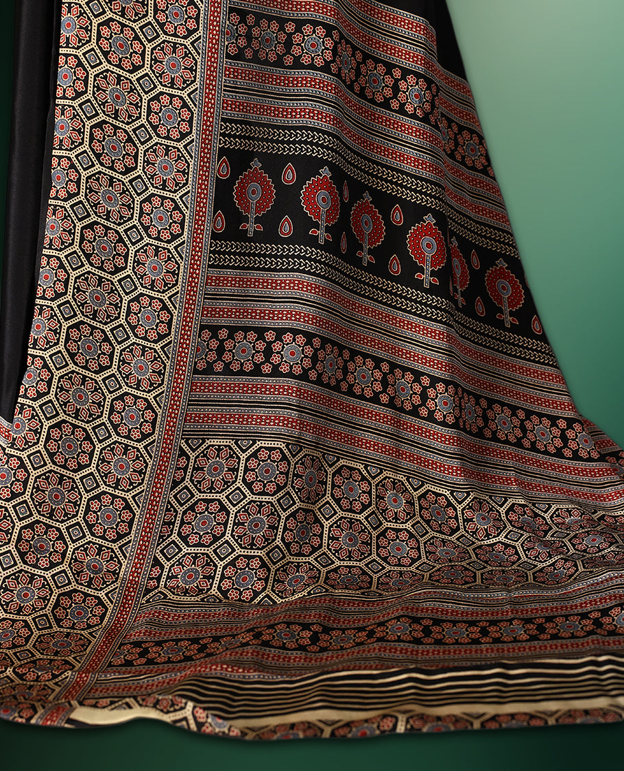 Black colour semi modal saree featuring an intricately woven multicolour ethnic patterned border and pallu, highlighted with traditional motifs, and paired with a matching blouse