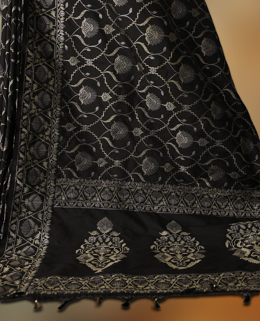 Classic black Banaras soft silk saree adorned with silver zari floral vines, detailed woven border, and grand paisley pallu, Comes with a matching blouse & A regal pick for festive and formal occasions.