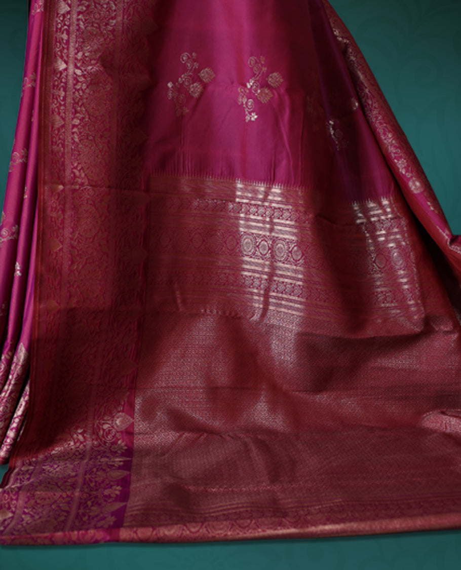 Pink colour semi silk saree featuring intricate golden zari floral motifs across the body, complemented by a rich maroon woven border and pallu, paired with a matching blouse.