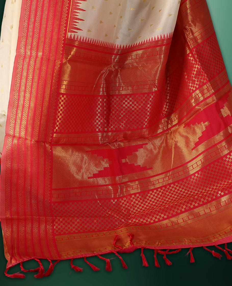 off white colour saree adorned with delicate golden motifs, accentuated by a vibrant red border with intricate weaving, and a rich red gold zari pallu, paired with a matching blouse