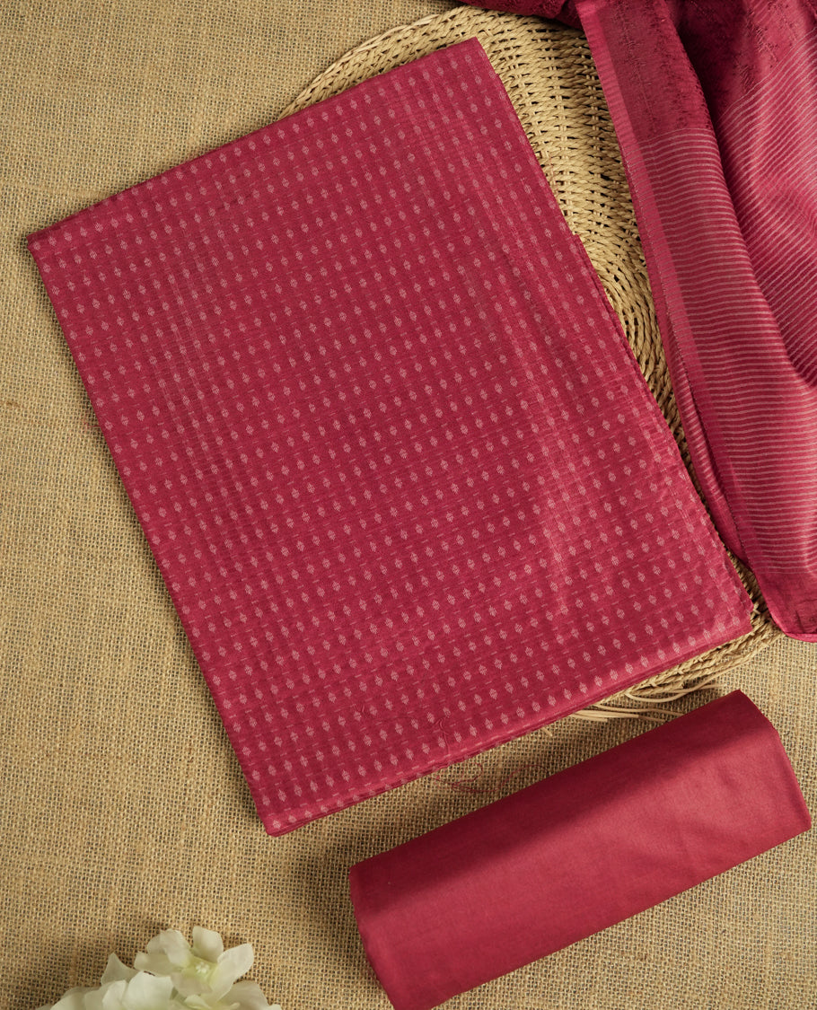 Light Maroon colour tussar suit material adorned with intricate woven patterns and subtle motifs, exuding ethnic elegance & Paired with a beautifully bordered dupatta and a matching plain bottom.