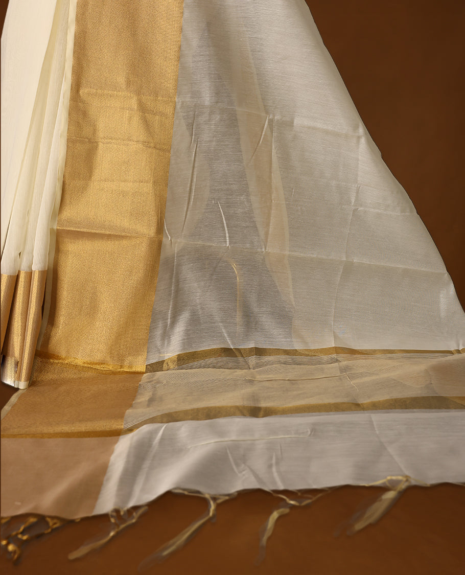 Elegant Off white colour Kerala saree with a traditional golden zari border and pallu, finished with golden tassels & A timeless ethnic piece, perfect for festivals and celebrations, paired with a matching blouse.