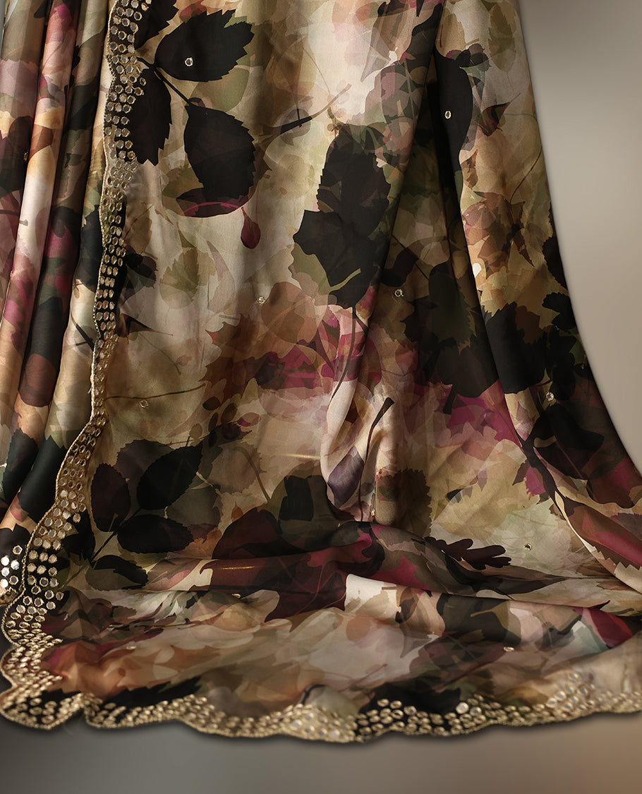 Beige colour pure crepe saree with abstract floral print in earthy tones, highlighted by mirror work on the body and scalloped border, paired with a matching blouse.