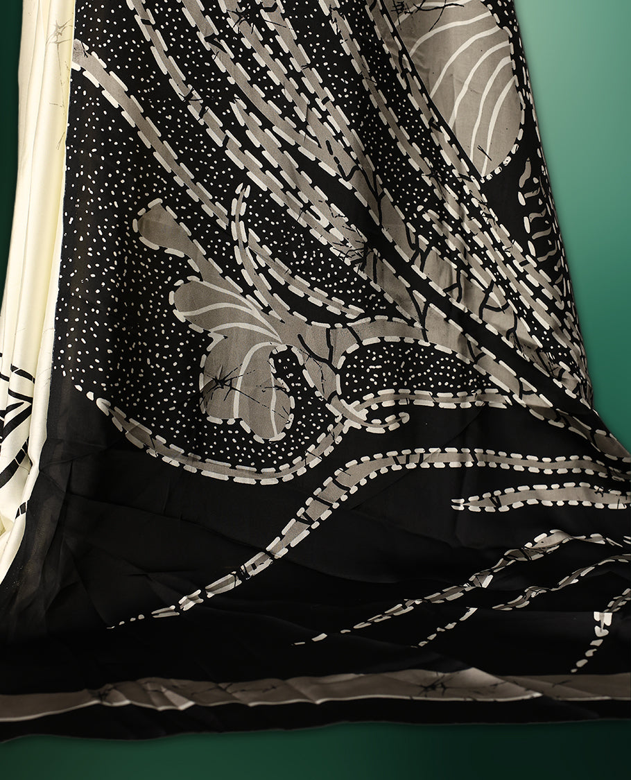 Black and white colour saree featuring abstract patterns with intricate dotted and floral motifs, creating a modern yet graceful look, paired with a matching blouse
