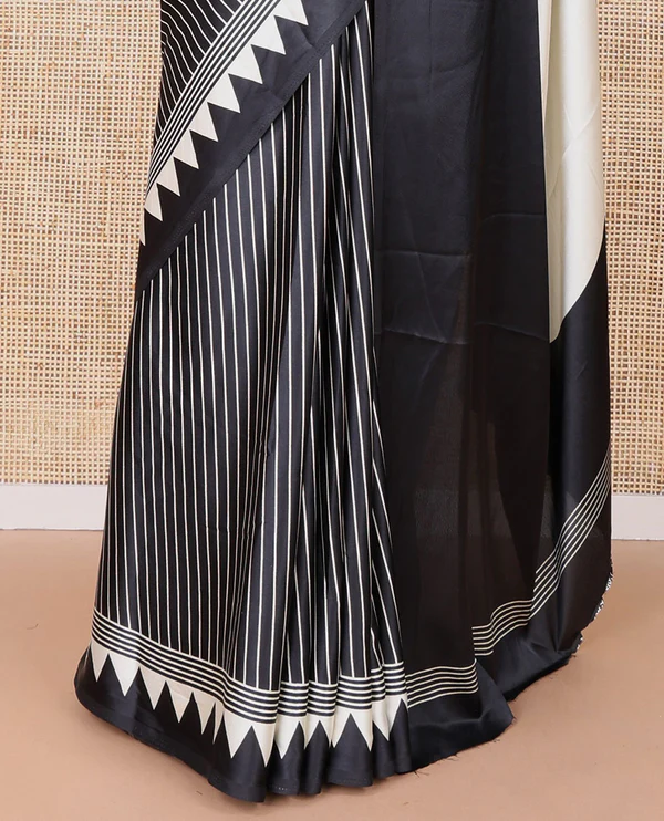 Black semi modal crepe saree featuring white vertical line prints, accented with a temple border and Bold circle Motif design on the pallu, paired with a matching printed blouse