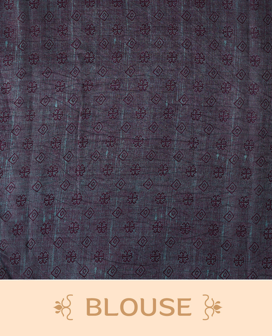 Plum purple colour Manipuri saree features a body with brick-red abstract motifs, highlighted by a contrasting indigo border and floral-printed pallu, and comes with a matching blouse.