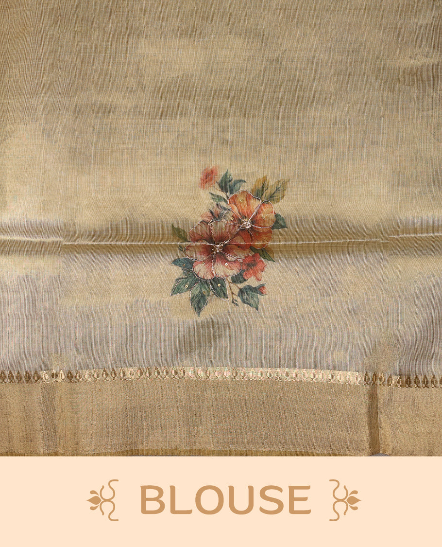 Light gold colour Organza Kerala saree featuring a smooth body with a subtle sheen, highlighted by a sleek golden zari border and delicate floral prints detailed with thread and sequence work near the pleats, Paired with a matching blouse.