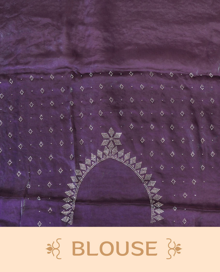 Dark purple colour chiffon designer saree, featuring delicate scattered stone detailing all over the body, highlighted with intricate stone work and a heavy geometric stone pattern along the border and pallu, paired with a matching embellished blouse.