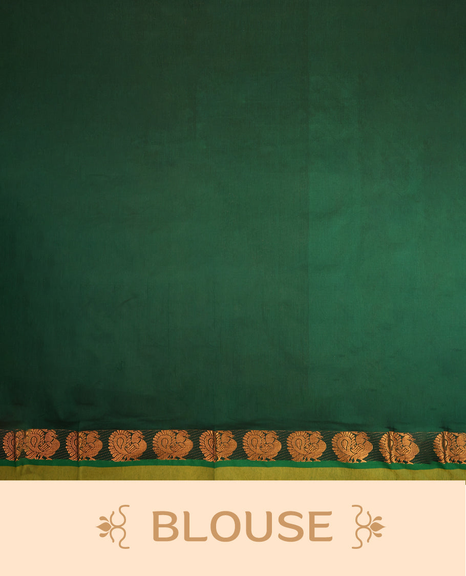Rust Orange colour mixed Kalyani cotton saree featuring Copper zari Peacock motifs throughout the body, paired with Bottle Green colour traditional border and pallu, with matching blouse