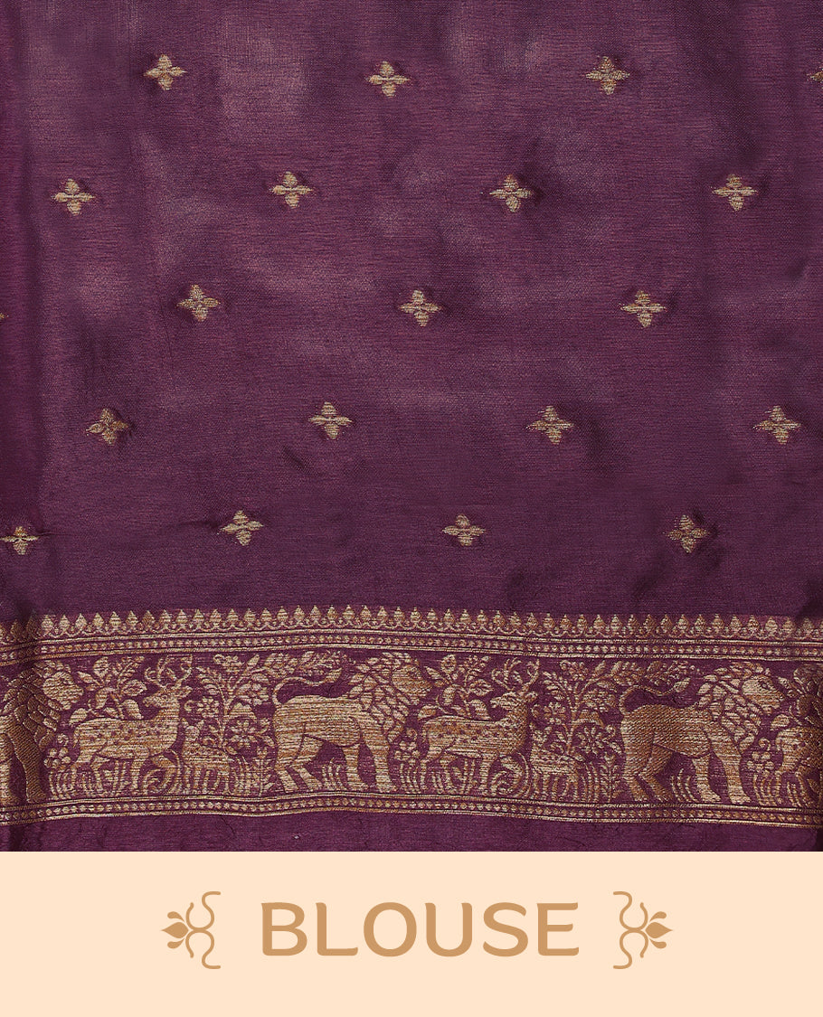 Light black currant semi Banaras tussar georgette saree adorned with antique zari butta motifs on the body, accentuated by a beautifully crafted jungle themed border, and paired with a matching blouse.