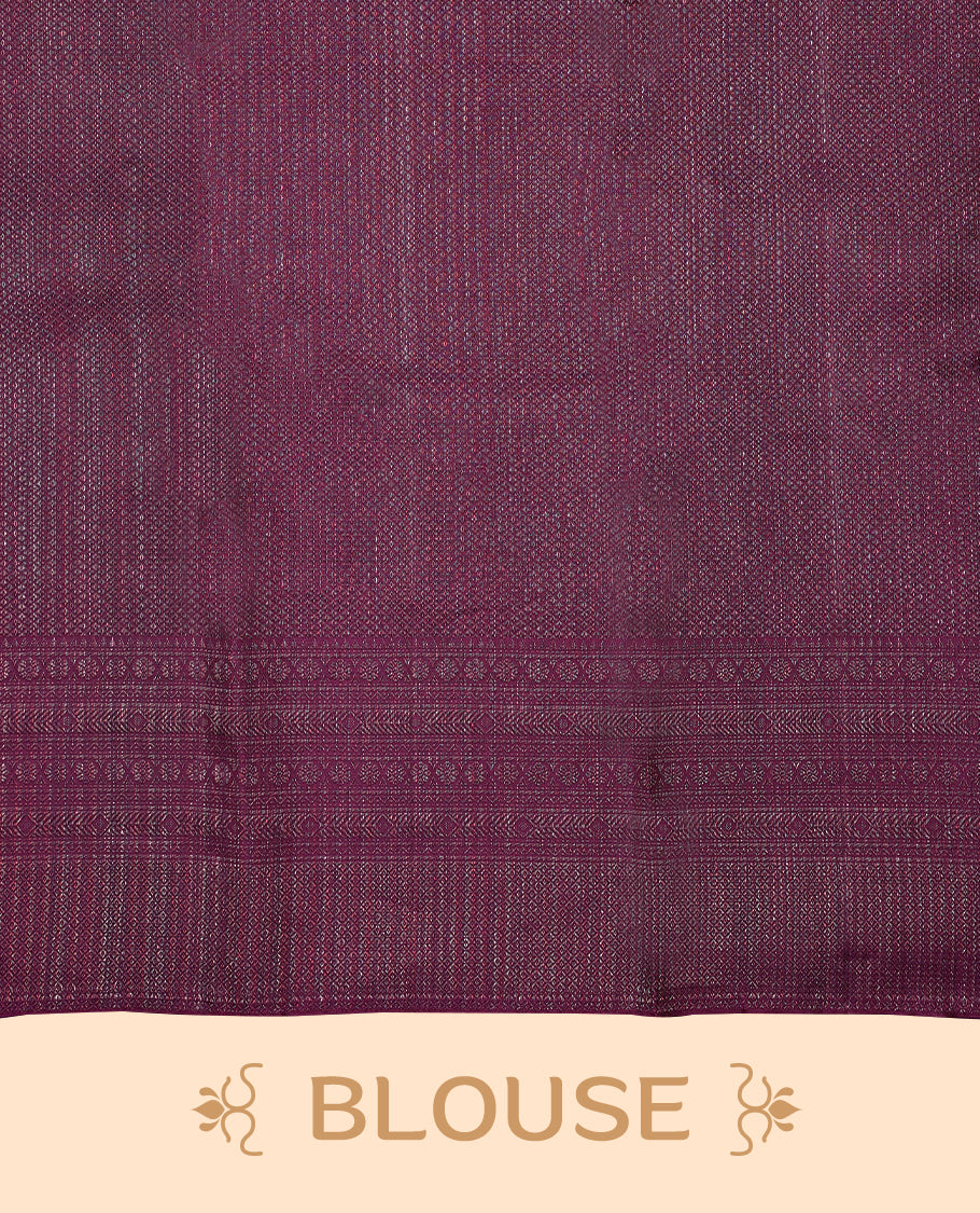 Grape coloured Manthrakodi saree featuring a multicoloured zari jacquard body, complemented by a self coloured turning Banarasi border and a matching self coloured blouse.