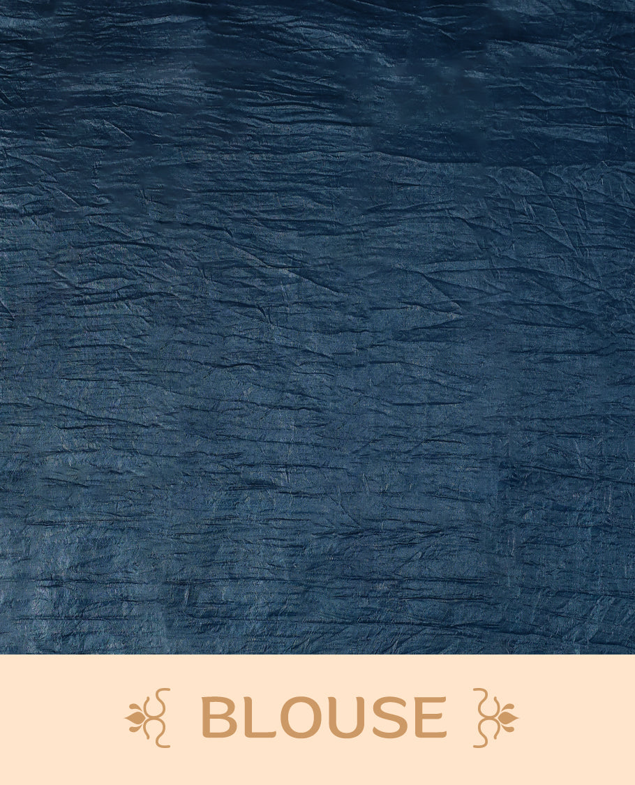 Midnight Blue Colour crush soft silk saree, textured body with a natural crinkled finish, adorned with intricate Silver colored floral Motifs and complemented by a delicate Silver Zari embroidery border, paired with a matching blouse
