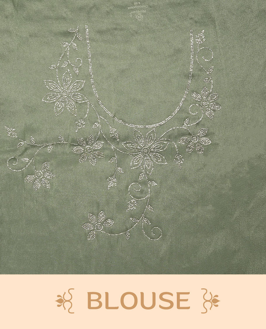 Pastel Mint colour net shimmer fancy saree adorned with white stone buttas all over the body, paired with a delicate stone worked border, with matching blouse