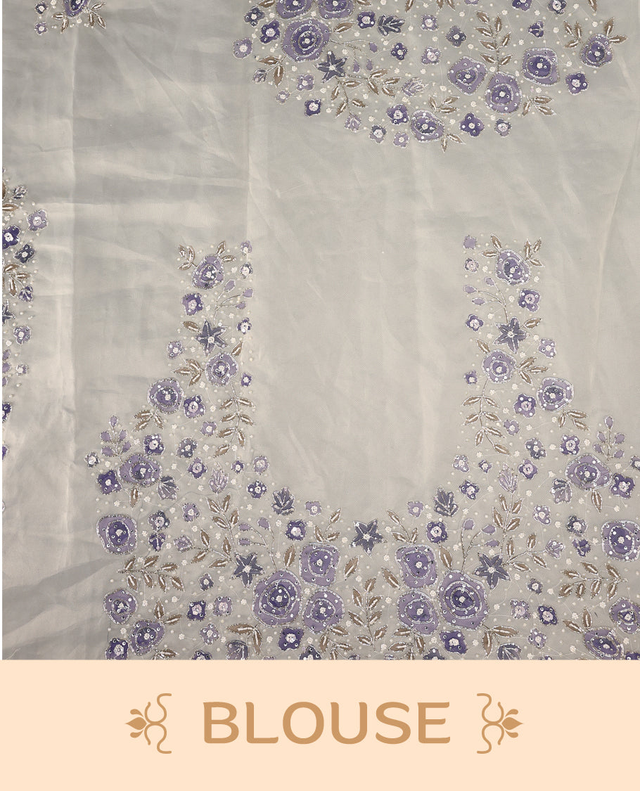 White colour pure organza saree featuring Lavender floral prints with intricate bead and sequin work across the body, adorned with a matching embellished border, complemented by a worked pallu and paired with a heavily worked matching blouse.
