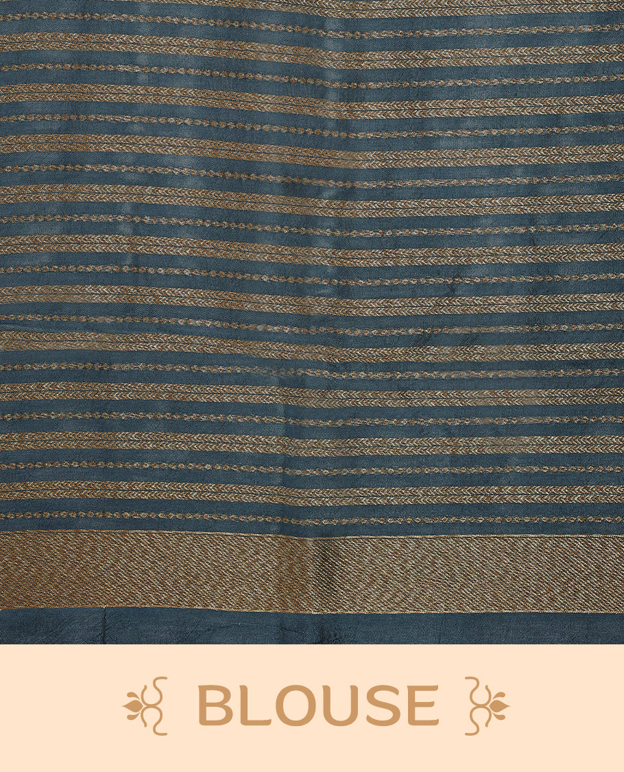 German blue semi-Banaras tussar georgette saree adorned with antique zari floral motifs on the body, beautifully highlighted with a pencil art garden-inspired border, paired with a matching blouse.