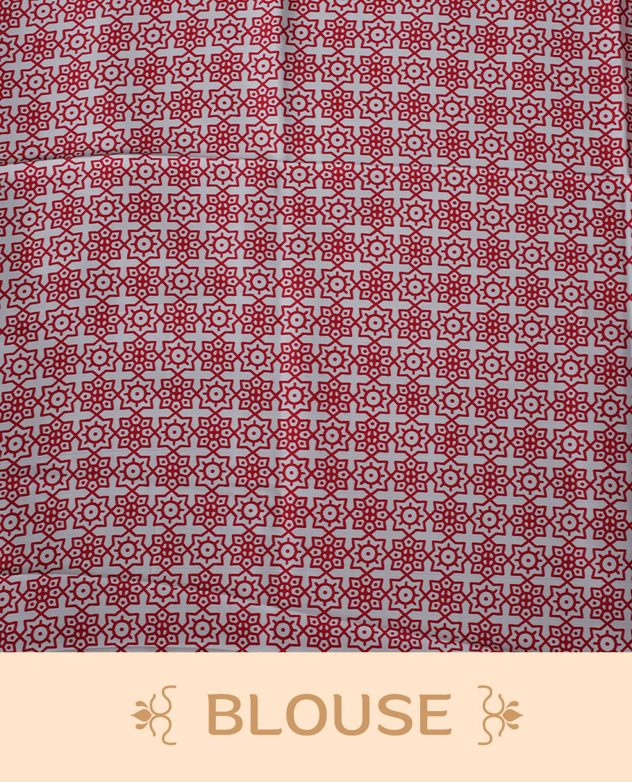 White colour semi modal saree highlighted with bold red triangle borders and fine striped detailing across the drape, featuring a striking oversized red circular motif on the pallu, paired with an all-over printed matching blouse.