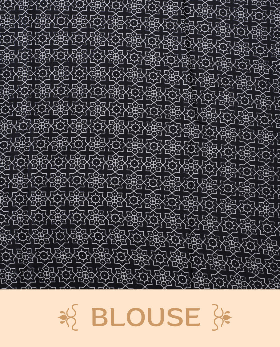 Black colour semi modal saree featuring white colour geometric borders and fine stripe detailing, finished with an oversized circular motif on the pallu, paired with a matching printed blouse.