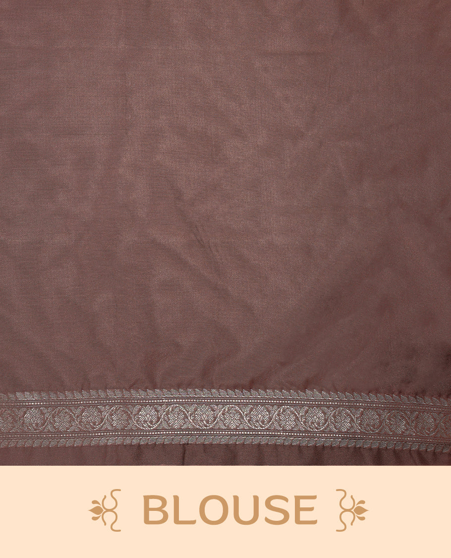 Pastel brown colour semi Banaras Katan saree featuring an antique silver zari jacquard body, complemented by a self colour traditional border with a floral kodi design, paired with a matching blouse