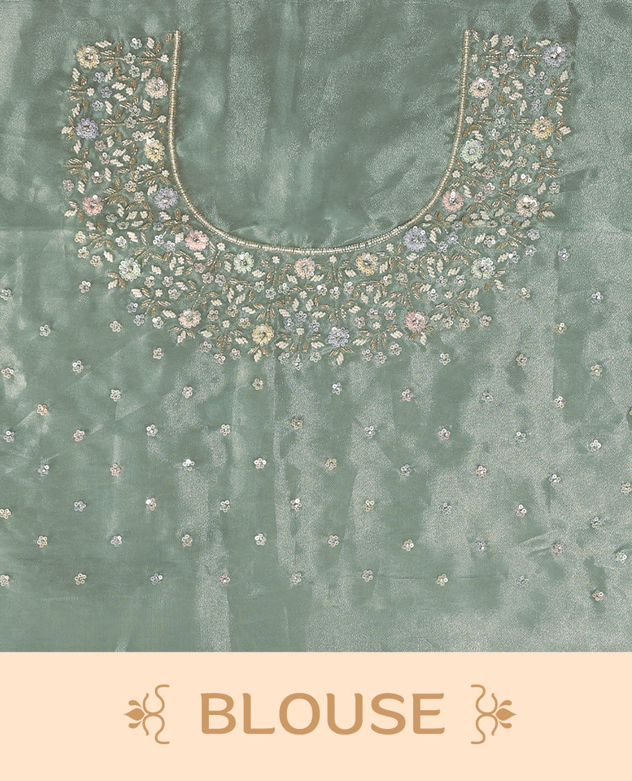 Aqua Green colour pure organza saree featuring all over floral sequin work, adorned with a matching intricately worked floral border, complemented by a richly embellished pallu and paired with a heavily worked matching blouse.