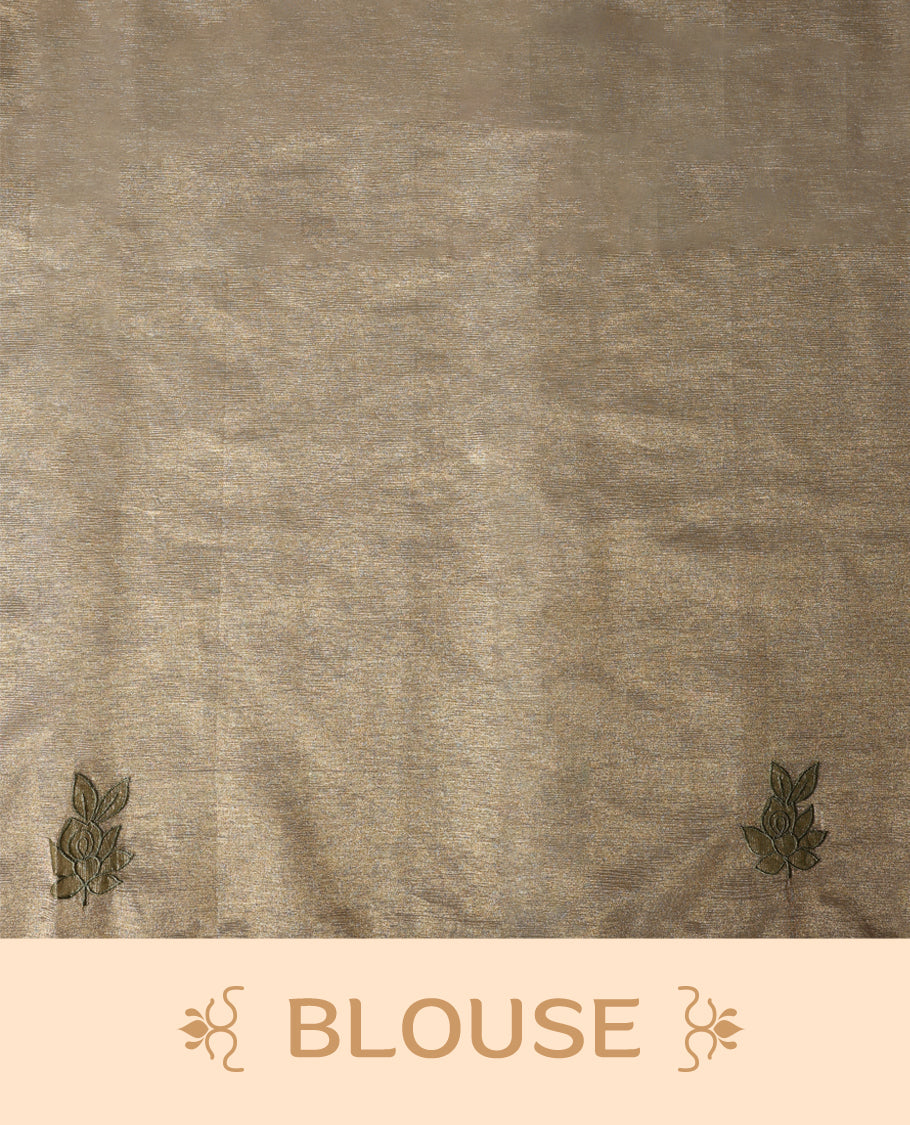 Beige gold colour organza designer saree featuring a subtle shimmer woven body with delicate green floral thread embroidery, scalloped thread detailing along the border and pallu paired with matching blouse.