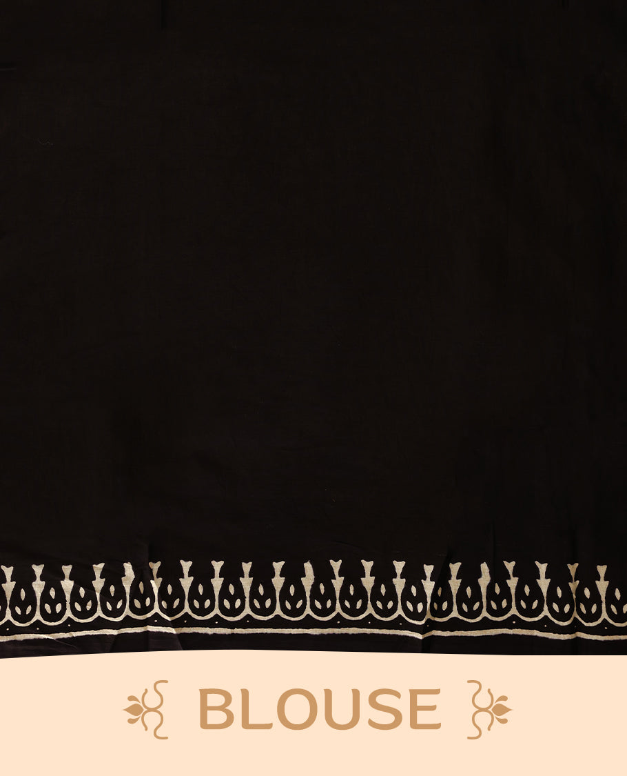 White cotton saree with black handblock prints, a detailed border enhanced with a combination of pink and orange piping, and with contrast blouse.