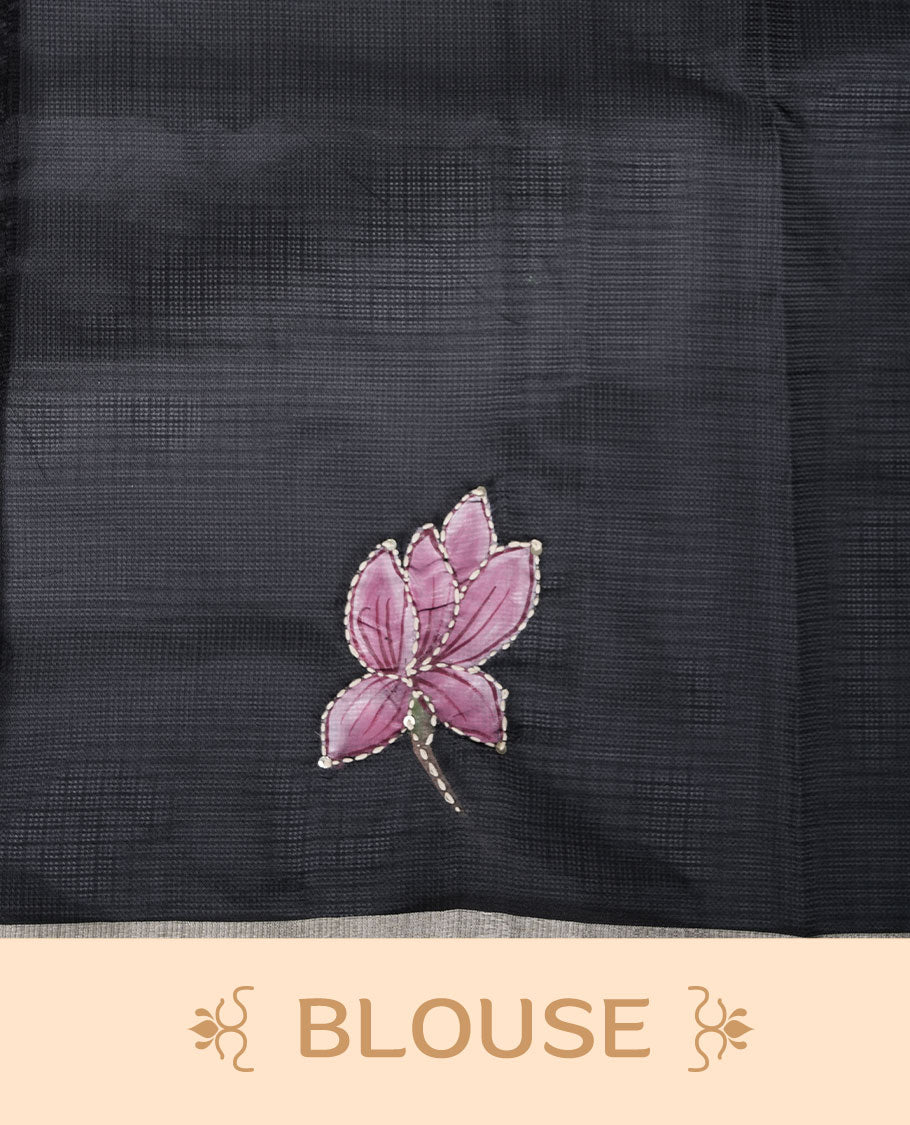 Black colour semi tusser silk saree featuring delicate floral embroidery motifs across the body with subtle contrast detailing on the border, paired with a matching embroidered blouse.