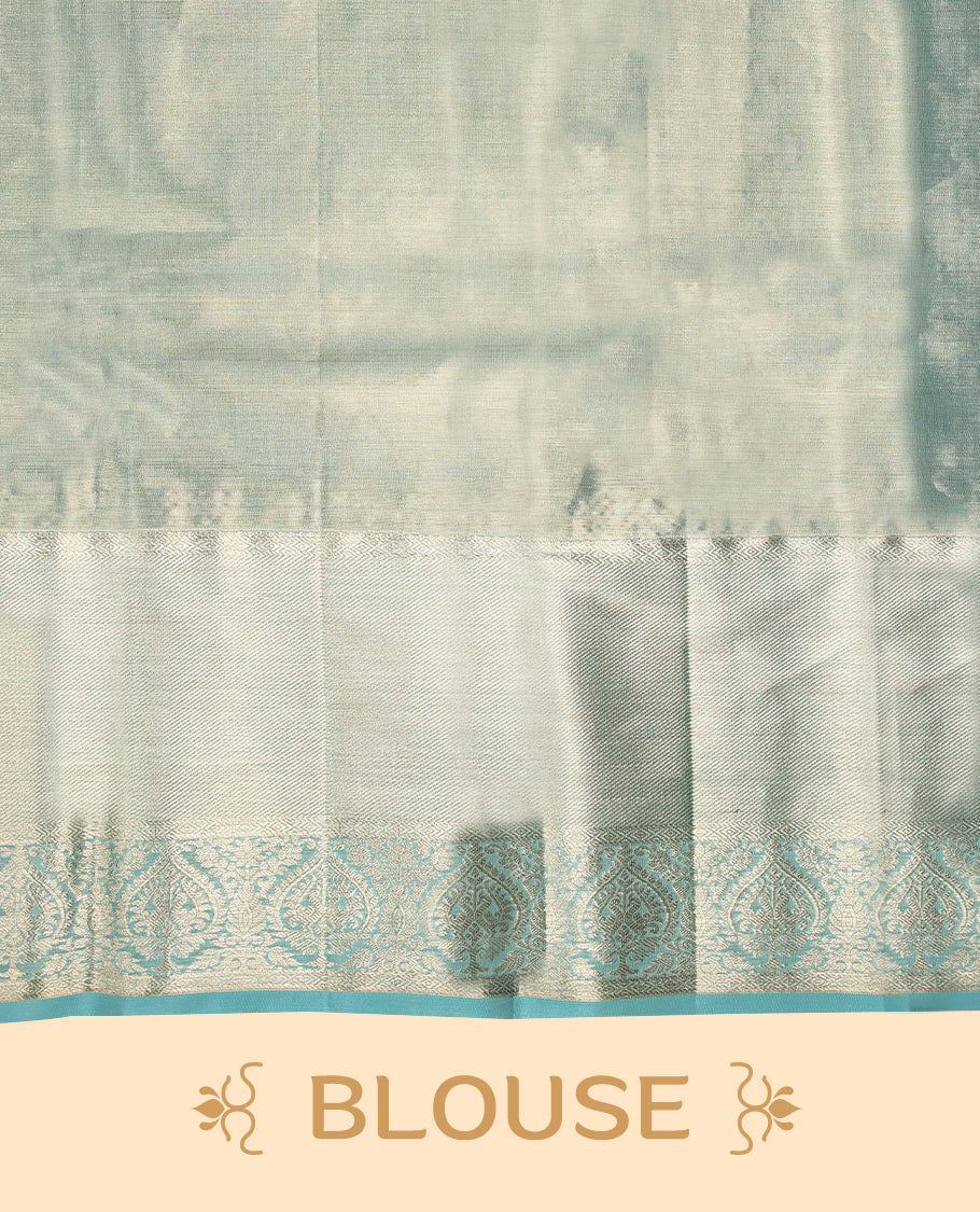 Silver Colour Kancheepuram tissue silk saree featuring intricate silver and blue zari leaf motifs on the body, gracefully complemented by a light blue traditional peacock and floral design border, and paired with a matching blouse.