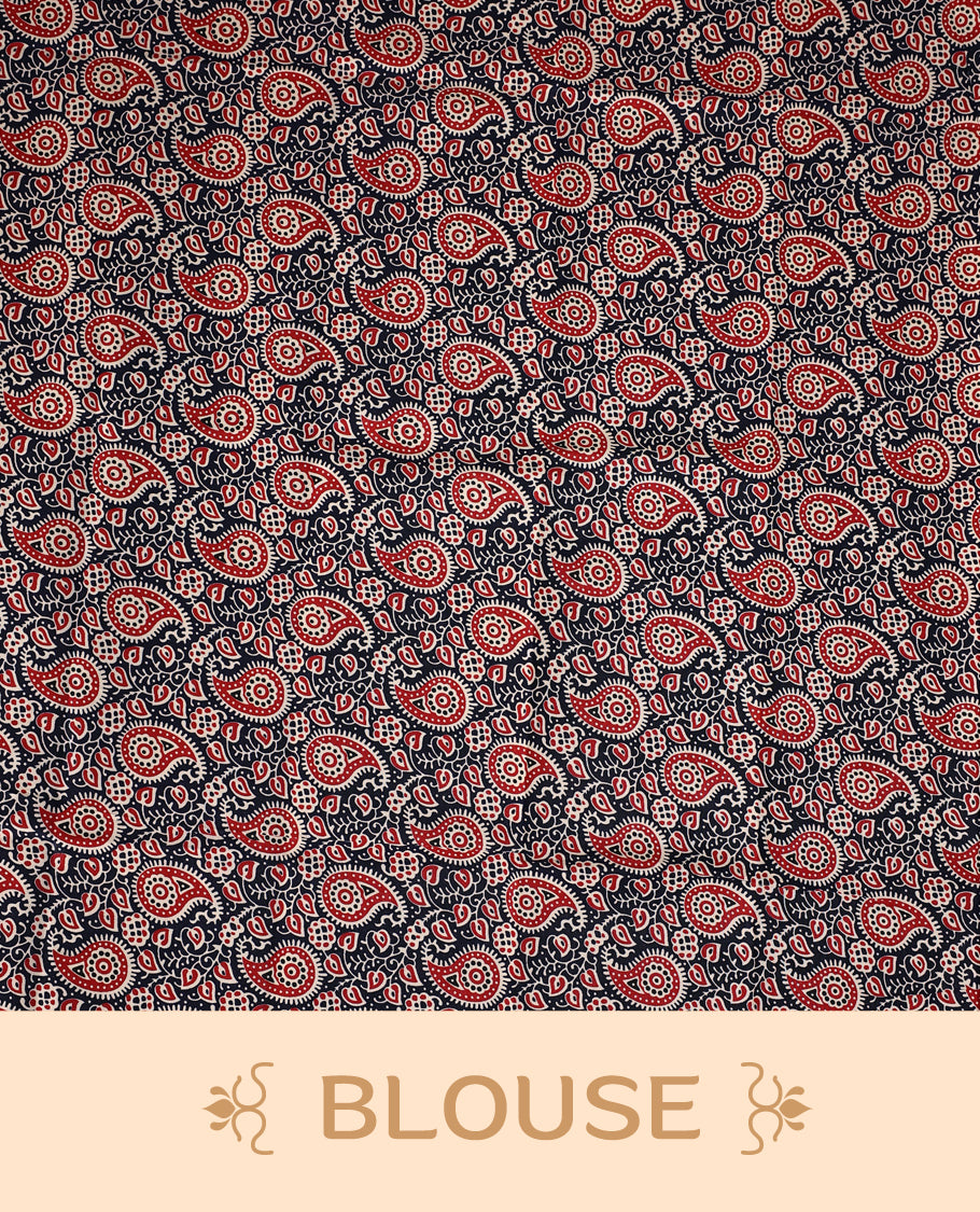 Off white colour cotton Kerala saree featuring a navy blue border with red and white paisley prints, paired with a matching printed blouse for a traditional yet vibrant look