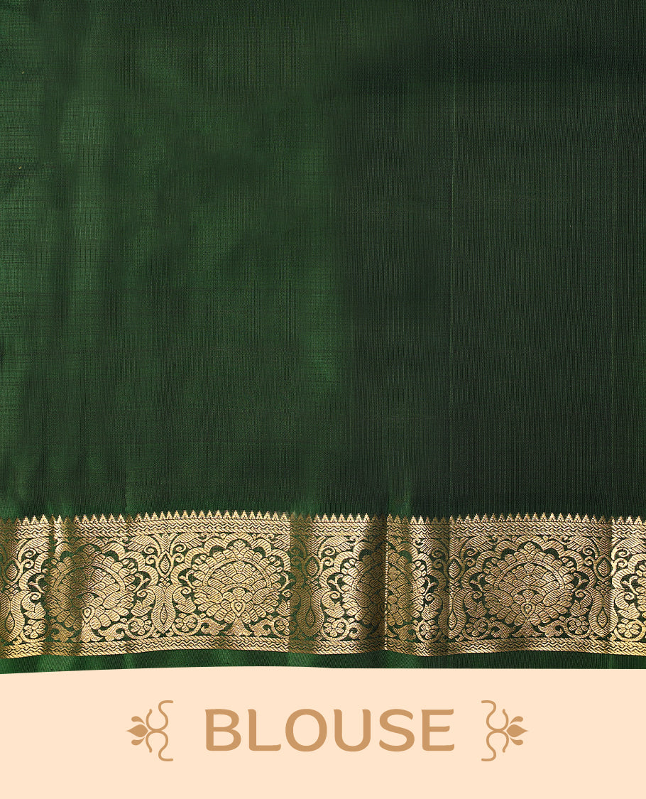 Solid mauve pink colour traditional Kancheepuram silk saree adorned with antique zari paisley motifs on the body, featuring a deep bottle green border with antique gold zari floral and vine patterns, and paired with a matching blouse.