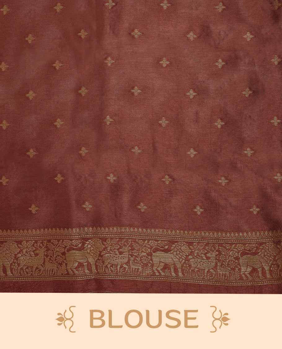 Rust Orange semi-Banaras tussar georgette saree adorned with antique zari butta motifs on the body, accentuated by a beautifully crafted jungle-themed border, and paired with a matching blouse.